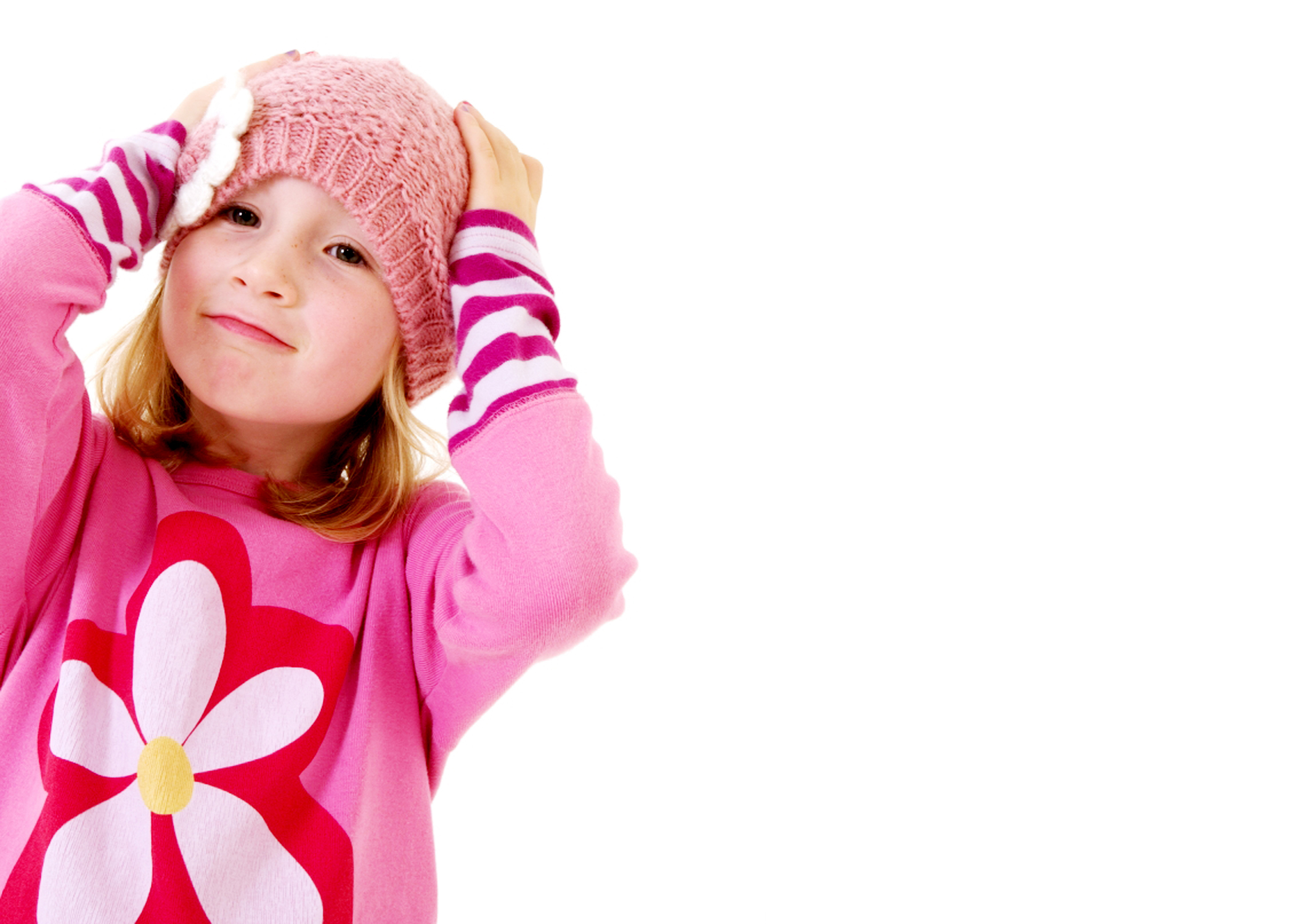 Young girl wearing pink with hands on head