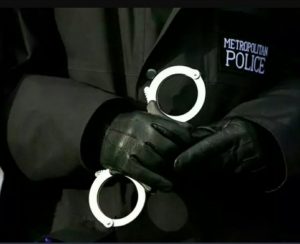 Police officer holding handcuffs